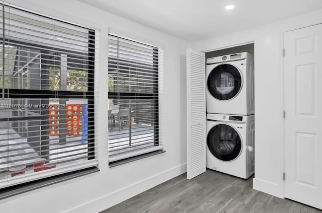 washroom with stacked washer / dryer and hardwood / wood-style floors