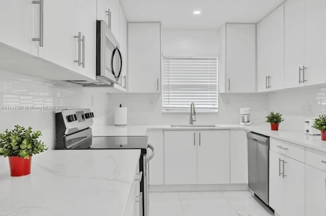 kitchen featuring white cabinets, sink, and stainless steel appliances