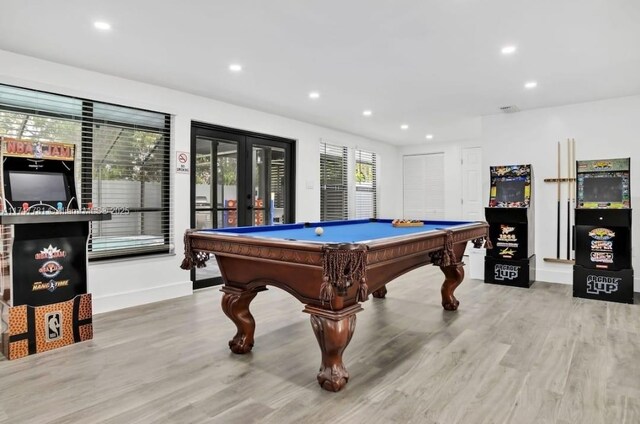 game room with french doors, light wood-type flooring, and pool table