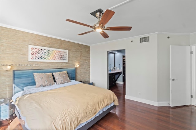 bedroom featuring ceiling fan, dark hardwood / wood-style flooring, ornamental molding, and ensuite bathroom