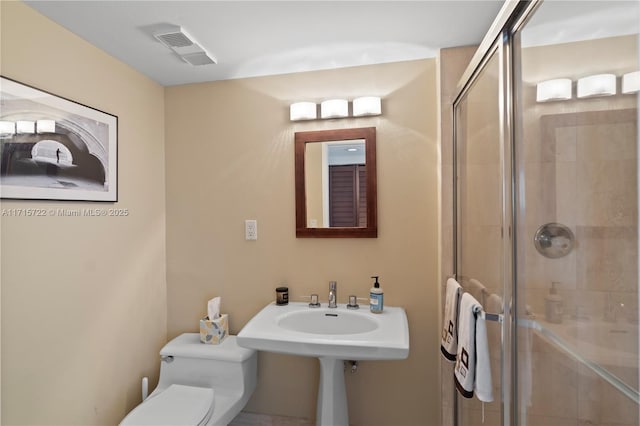 bathroom with toilet and walk in shower