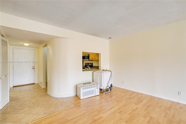 empty room with light hardwood / wood-style floors and sink