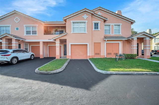 view of front facade featuring a front yard and a garage