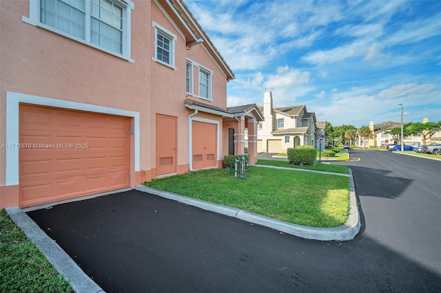 exterior space featuring a yard and a garage