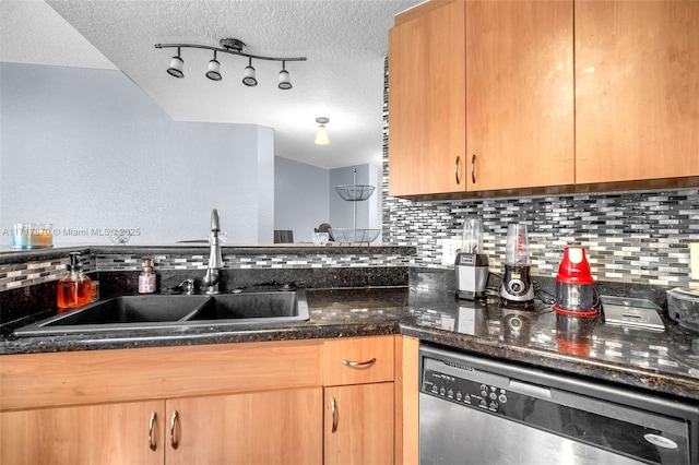 kitchen featuring backsplash, dark stone counters, a textured ceiling, sink, and dishwasher