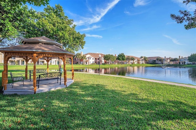 view of home's community with a gazebo, a lawn, and a water view