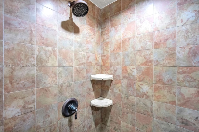 bathroom with a tile shower