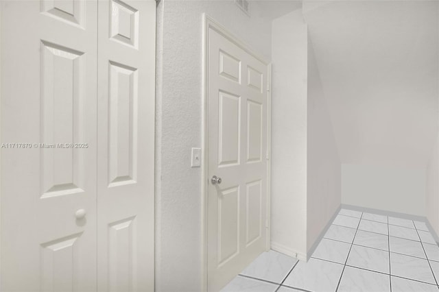 hallway with light tile patterned floors