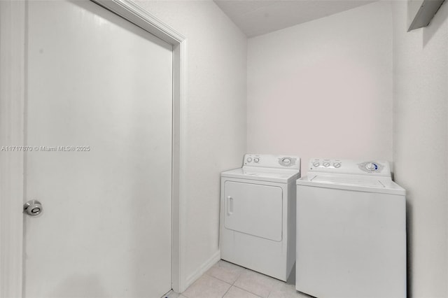 laundry room featuring light tile patterned flooring and washer and dryer