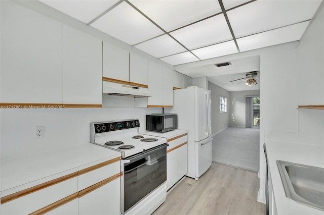 kitchen with ceiling fan, white appliances, white cabinets, light hardwood / wood-style flooring, and sink