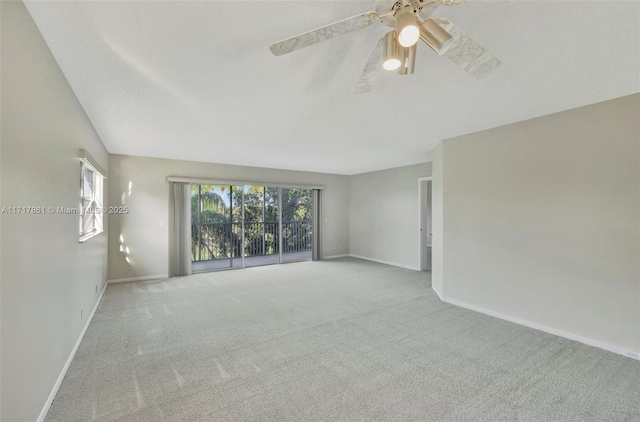 carpeted spare room with ceiling fan