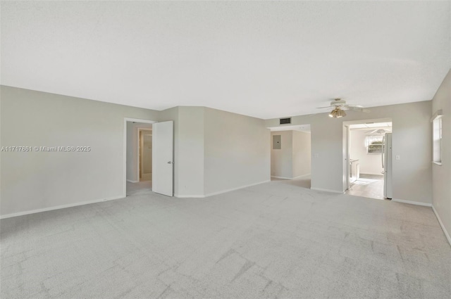 unfurnished room featuring light carpet and ceiling fan