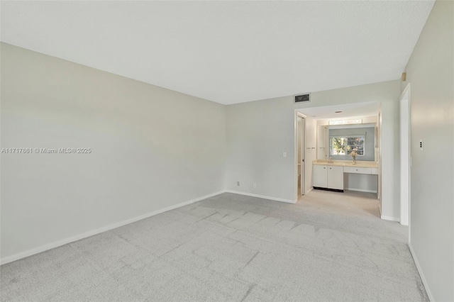 unfurnished room with light colored carpet