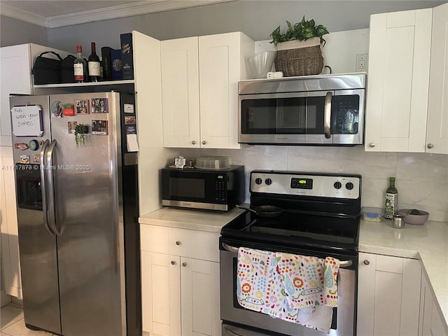 kitchen with white cabinets, stainless steel appliances, tasteful backsplash, and crown molding