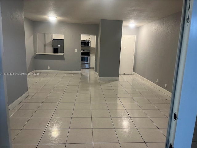 unfurnished living room featuring light tile patterned floors