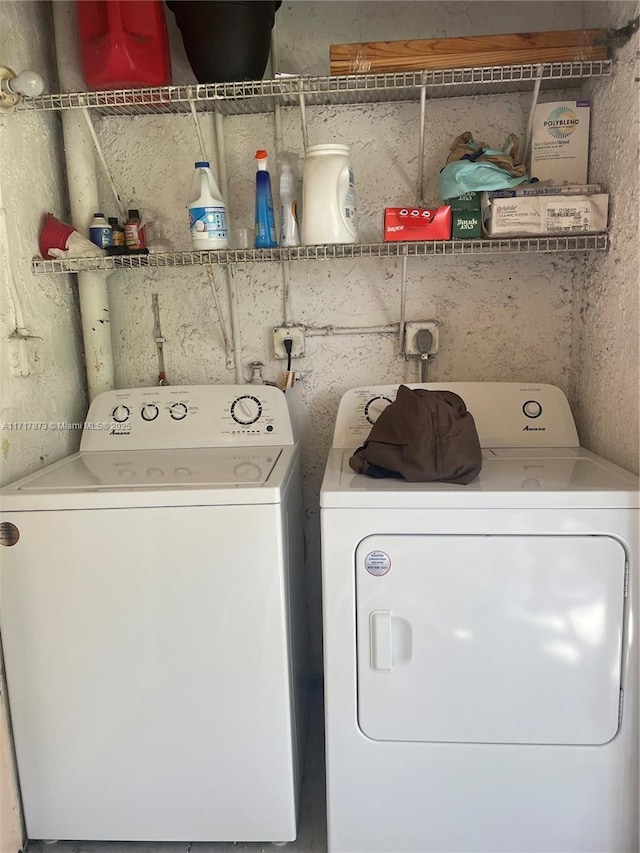 laundry room with washing machine and clothes dryer