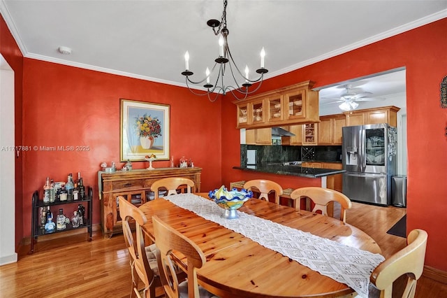 dining room with ceiling fan with notable chandelier, light hardwood / wood-style flooring, and crown molding