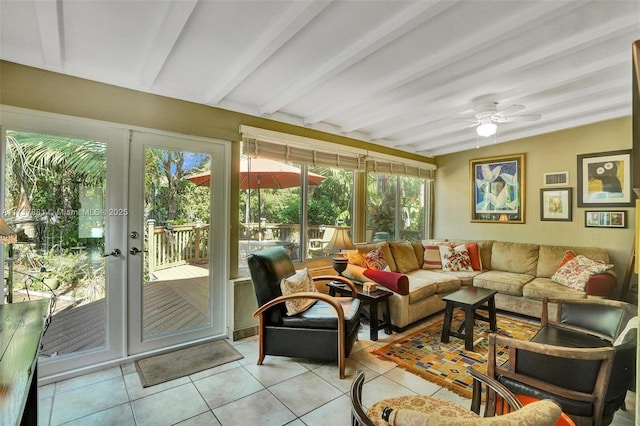 sunroom / solarium with beam ceiling, ceiling fan, and french doors