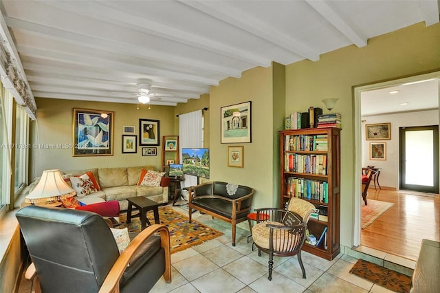 living room featuring light tile patterned floors, ceiling fan, and beam ceiling