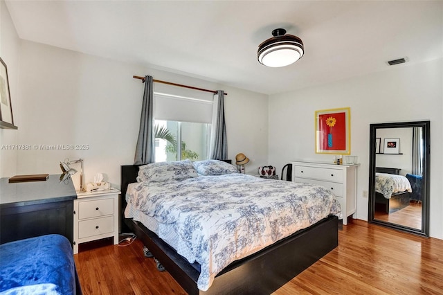 bedroom with hardwood / wood-style flooring