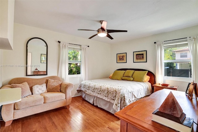 bedroom featuring multiple windows, ceiling fan, and light hardwood / wood-style floors