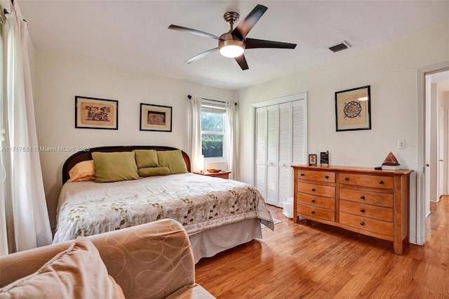 bedroom featuring light hardwood / wood-style floors, a closet, and ceiling fan