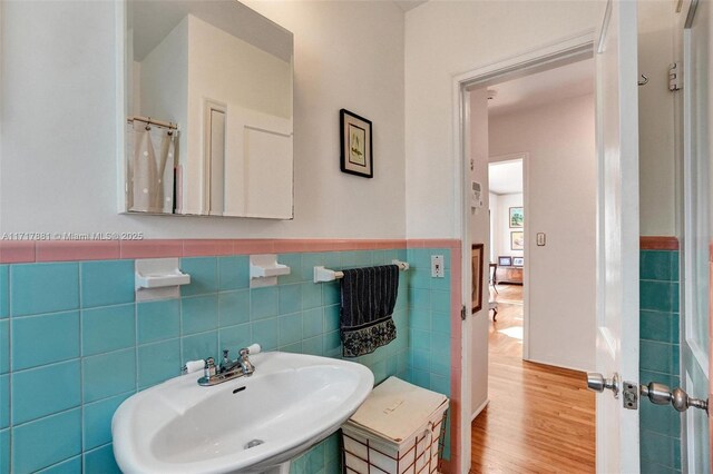 bathroom featuring tile walls, sink, and wood-type flooring