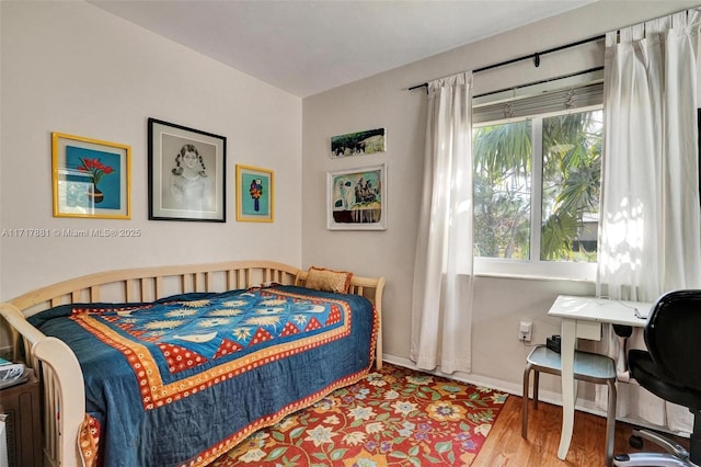 bedroom with hardwood / wood-style flooring