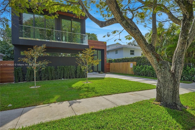 contemporary home featuring a front lawn