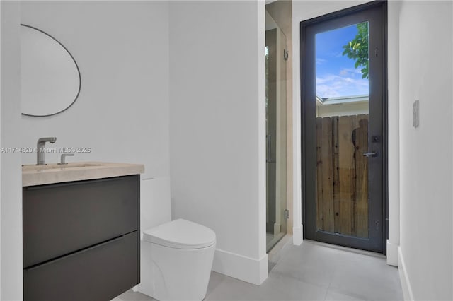 bathroom featuring a shower, tile patterned flooring, vanity, and toilet