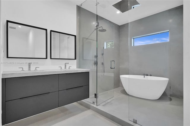 bathroom with vanity and independent shower and bath