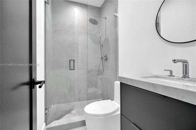 bathroom with vanity, toilet, and an enclosed shower