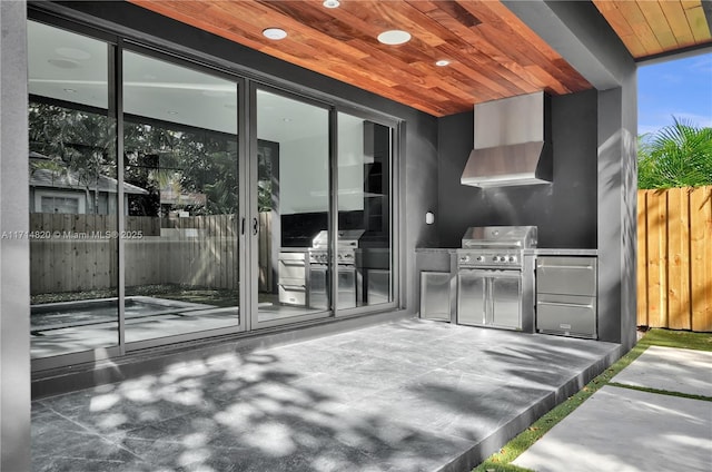 view of patio with an outdoor kitchen and a grill