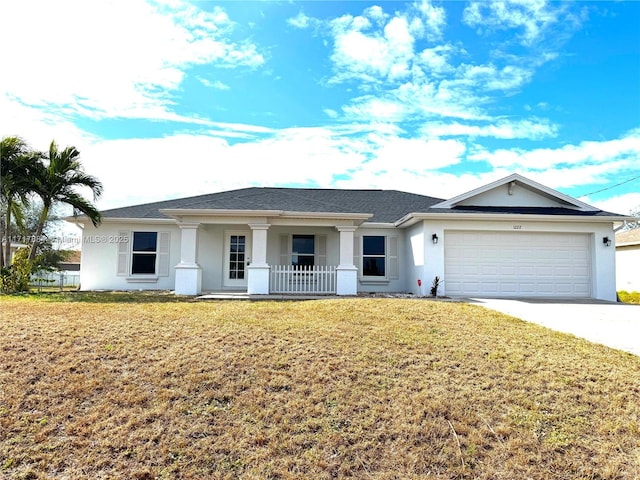 ranch-style house featuring covered porch, a garage, and a front lawn