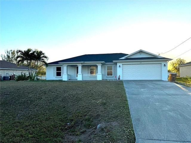 single story home featuring a front yard, a porch, and a garage