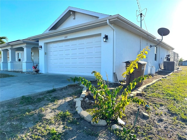 view of side of property featuring cooling unit and a garage