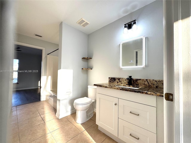 bathroom with tile patterned flooring, vanity, and toilet