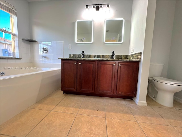 bathroom featuring tile patterned flooring, toilet, a bathing tub, and vanity