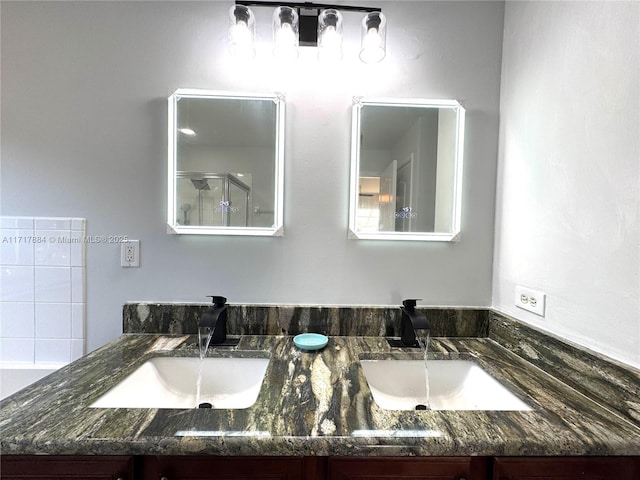 bathroom with vanity and a shower with shower door