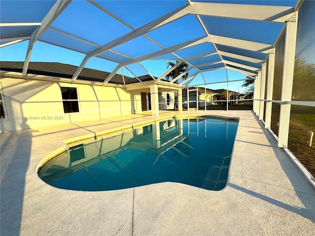 view of swimming pool with glass enclosure and a patio