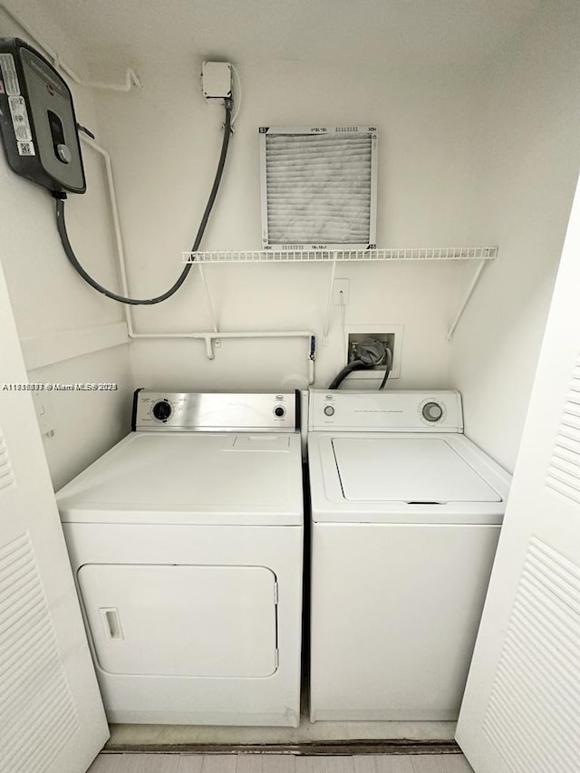 clothes washing area with washer and dryer