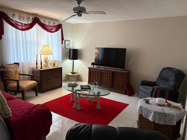 tiled living room with ceiling fan and a textured ceiling