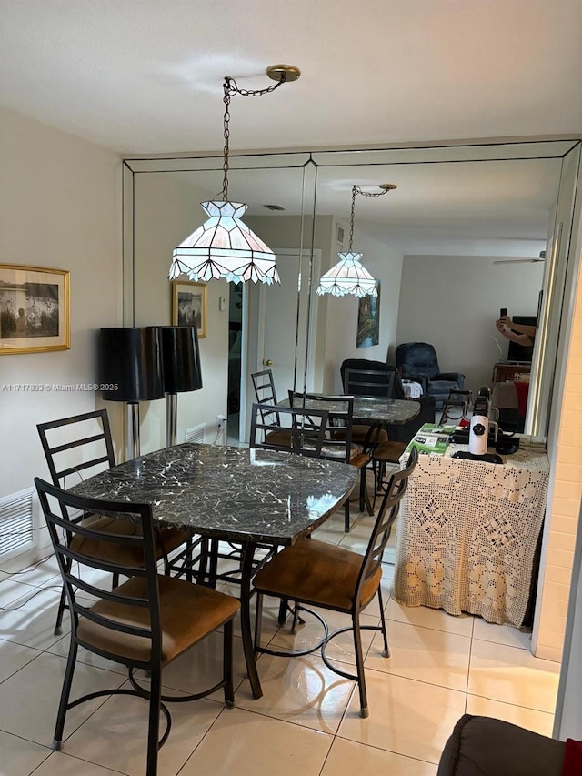 dining area featuring light tile patterned floors