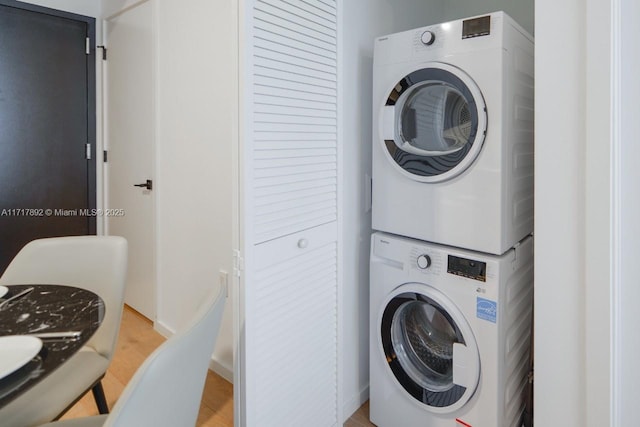 clothes washing area with stacked washer and dryer