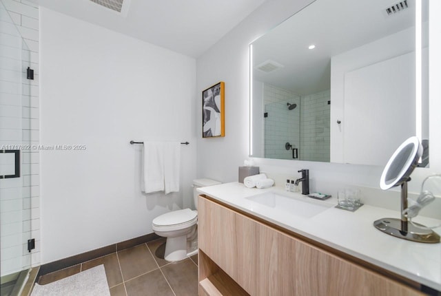 bathroom with tile patterned flooring, vanity, toilet, and a shower with door