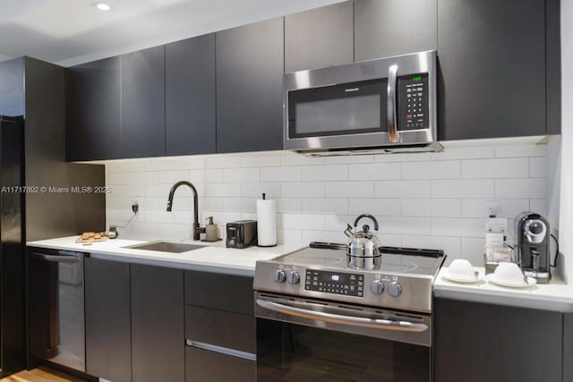 398 NE 5th St Unit 2810, Miami, FL 33132 - kitchen with appliances with stainless steel finishes, a sink, backsplash, and light countertops