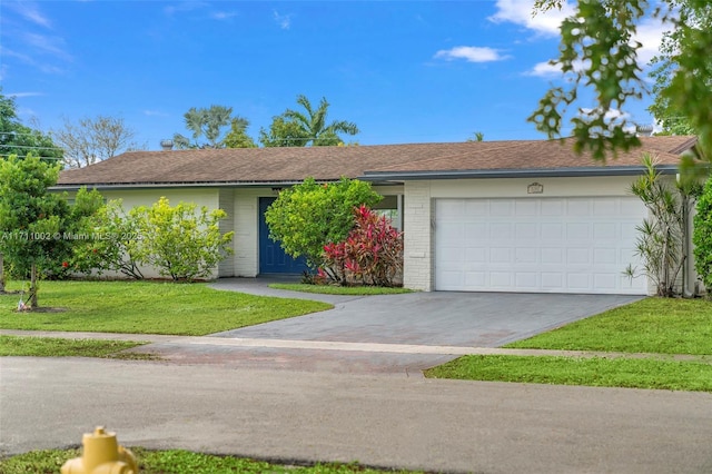 single story home featuring a front yard and a garage