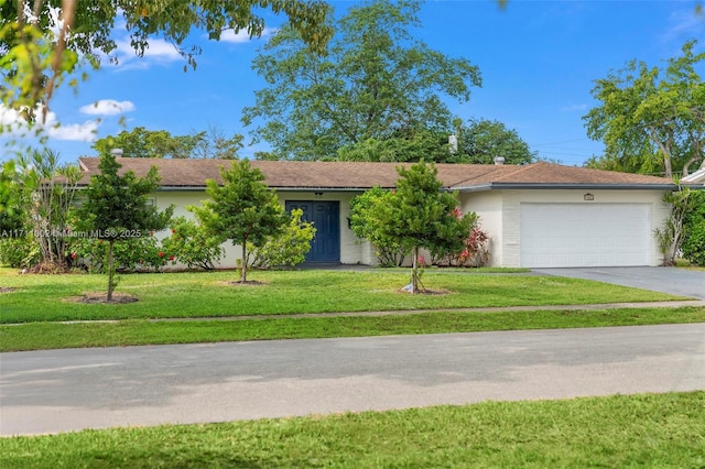 single story home with a garage and a front lawn