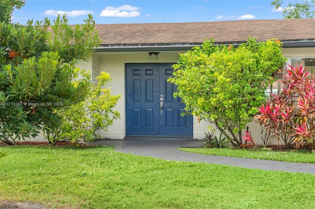 property entrance with a yard