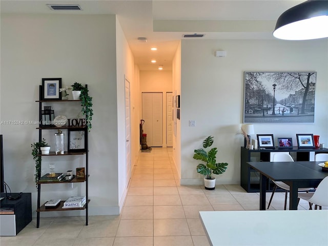 hall featuring light tile patterned flooring